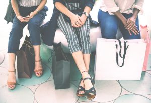 Girls sitting with shopping bags