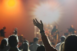 People waving hands at a concert