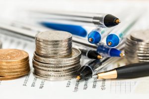 coins an pencils on the table for budget when things to think about before moving