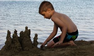 a kid making sand castle