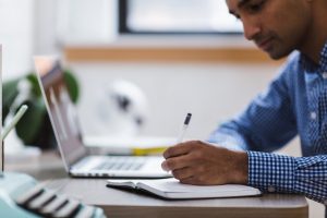 A man doing a research in order to reduce stress when moving abroad