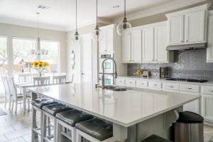 White kitchen with a white kitchen island.