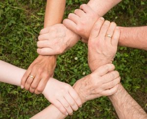 Close up of people holding hands. 