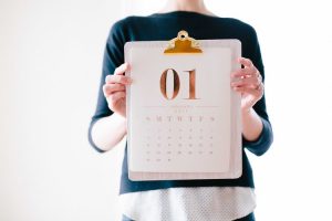 Person holding a calendar.