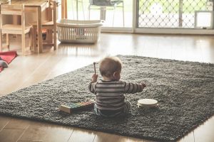 A toddler playing on the floor.