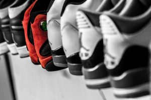 Sneakers lined on a shelf.