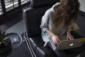 woman writing on laptop - reward movers for a job well done