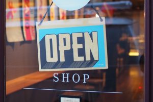 Shop sign saying open.