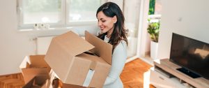 residential movers Florida - woman holding a box in the house