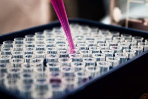 Scientist filling vials.