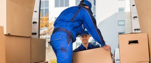 two men taking boxes out of the truck