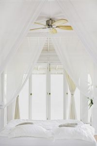 White bedroom with curtains.