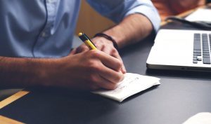 man writing a plan