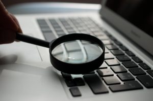 A magnifying glass on a keyboard