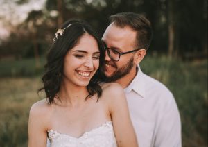 A groom embracing his bride - a couple this happy should easily combine two households without stress!