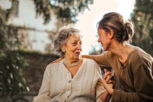 A young woman meeting her elderly neighbor.