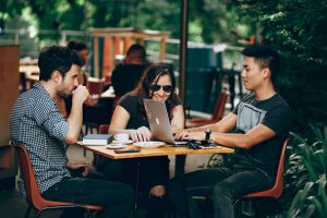 Three friends hanging out in a coffee shop. 