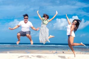 Three friends having fun at a sunny beach.