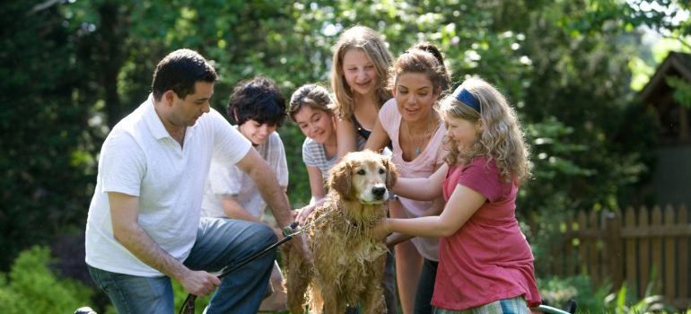 a family surrounding their dog