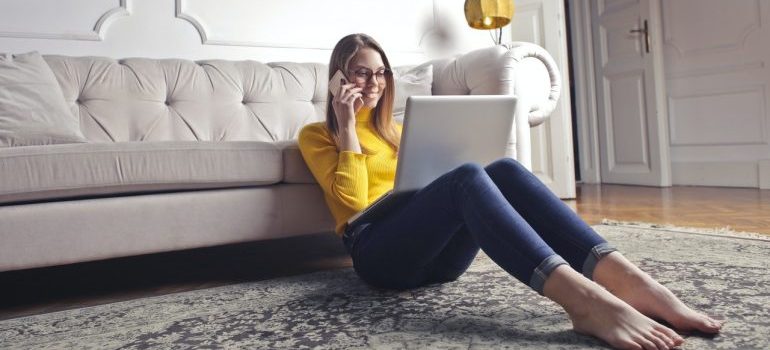 Woman talking on phone and using laptop