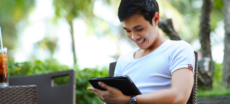 a man using a tablet to find Daytona Beach local movers