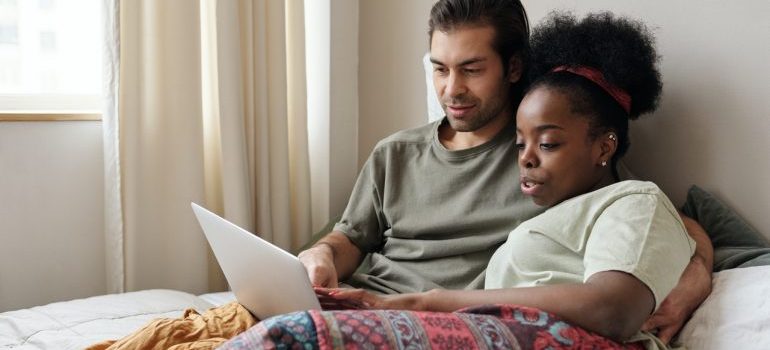 couple booking residential movers Miami on their laptop