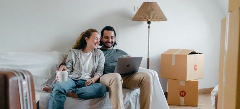 Couple searching for residential movers Orlando on their laptop