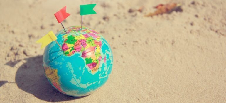 A globe on the sand.