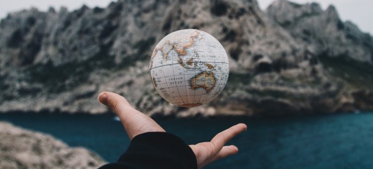 A person tossing a globe