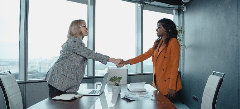 two women shaking hands