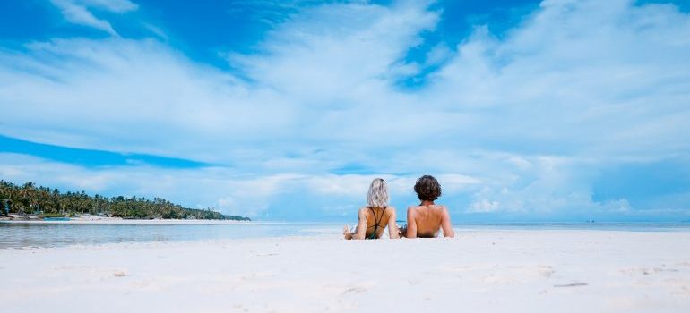 A young couple on a white sandy beach after the move with local movers Delray Beach