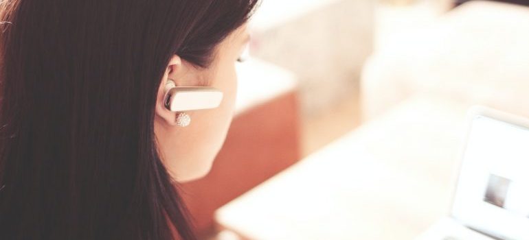 woman working in customer service with earphones