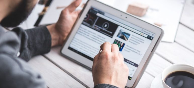 person using tablet, reading