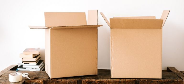 A couple of cardboard boxes on a wooden surface.