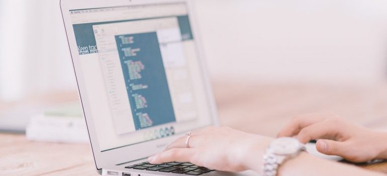 A woman searching through a database on a laptop.