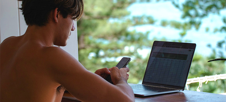 A man using mobile phone to find residential movers palm beach