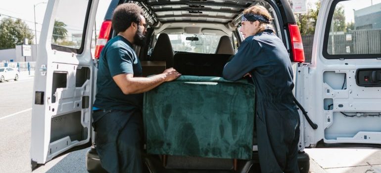 Movers loading household items on a moving vehicle