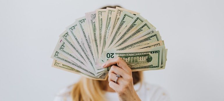 faceless woman holding money 