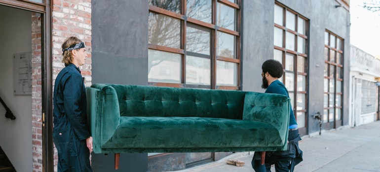 movers holding a big couch