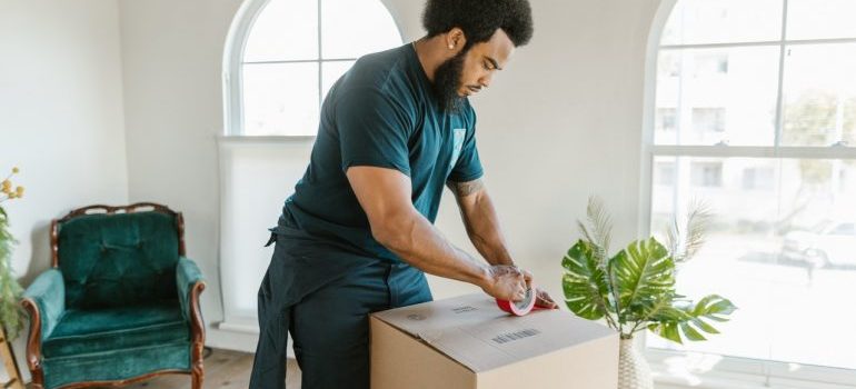 mover packing items into a moving box