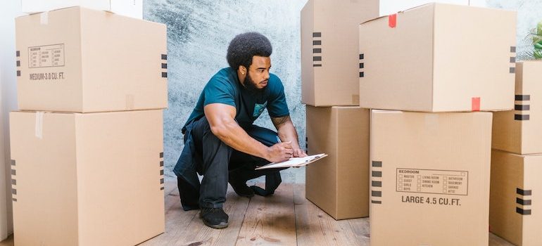 man surrounded by boxes