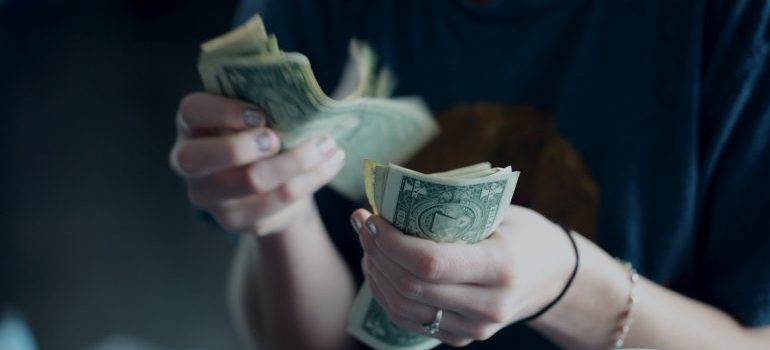 A person counting money in his hands