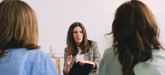 woman discussing details with clients about relocation 