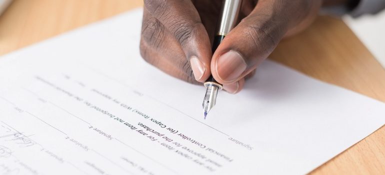 person signing a contract