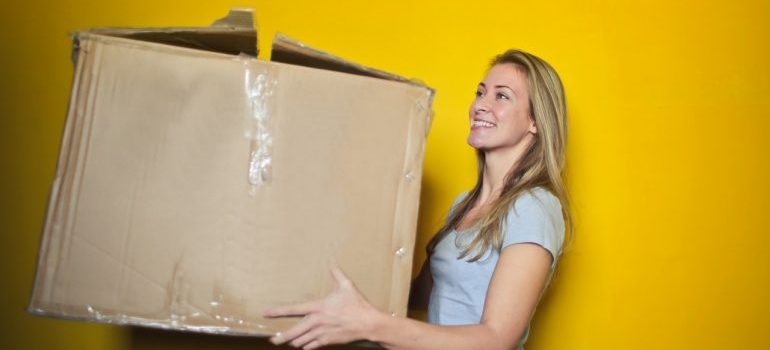 a woman carrying a box