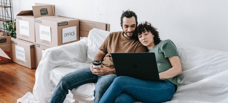 couple looking at local movers Gainesville FL on their laptop