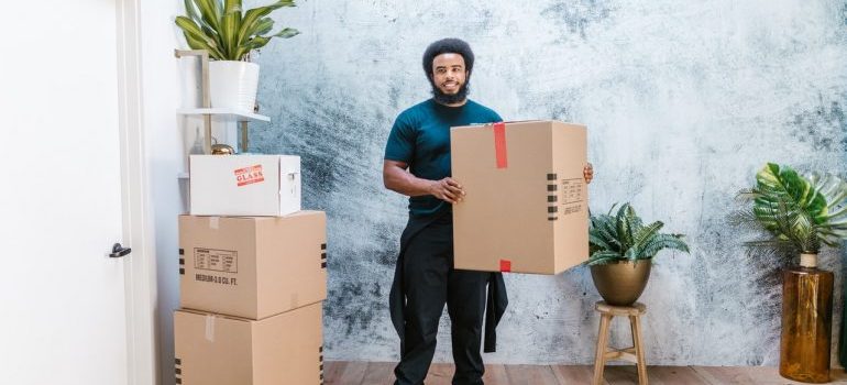 mover holding a cardboard box