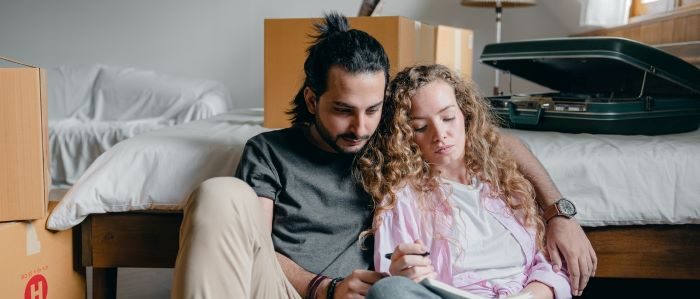 A couple in the middle of a move, making a checklist.