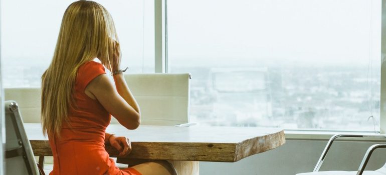 woman looking through a foggy window