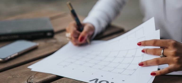 A woman browsing through a calendar.